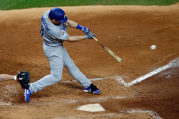 HOUSTON, TX - OCTOBER 28: Logan Forsythe #11 of the Los Angeles Dodgers hits a RBI single during the seventh inning against the Houston Astros in game four of the 2017 World Series at Minute Maid Park on October 28, 2017 in Houston, Texas.  (Photo by Bob Levey/Getty Images)