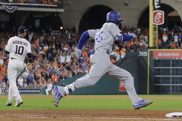 Los Angeles Dodgers' Cody Bellinger rounds first after hitting an RBI double during the ninth inning of Game 4 of baseball's World Series against the Houston Astros Saturday, Oct. 28, 2017, in Houston. (AP Photo/David J. Phillip)