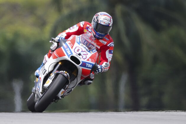 Italy's MotoGP rider Andrea Dovizioso steers his Ducati during the qualifying session of the Malaysia MotoGP at the Sepang International circuit in Sepang, Malaysia, Saturday, Oct. 28, 2017. (AP Photo/Vincent Phoon)