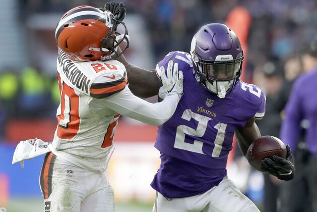 Minnesota Vikings running back Jerick McKinnon (21) runs with the ball as Cleveland Browns safety Briean Boddy-Calhoun (20) defends during the second half of an NFL football game at Twickenham Stadium in London, Sunday Oct. 29, 2017. (AP Photo/Matt Dunham)