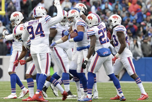 Buffalo Bills players celebrate after strong safety Micah Hyde, center, made an interception on a pass from Oakland Raiders quarterback Derek Carr, not pictured, during the second half of an NFL football game, Sunday, Oct. 29, 2017, in Orchard Park, N.J. (AP Photo/Adrian Kraus)