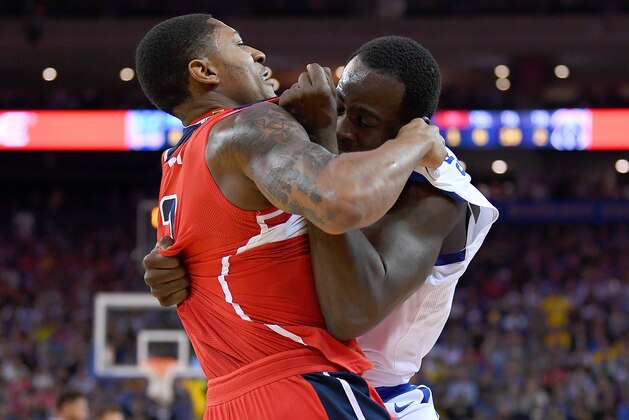 OAKLAND, CA - OCTOBER 27:  Draymond Green #23 of the Golden State Warriors and Bradley Beal #3 of the Washington Wizards gets tangled up in a fight during the second quarter of their NBA basketball game at ORACLE Arena on October 27, 2017 in Oakland, California. NOTE TO USER: User expressly acknowledges and agrees that, by downloading and or using this photograph, User is consenting to the terms and conditions of the Getty Images License Agreement. (Photo by Thearon W. Henderson/Getty Images)