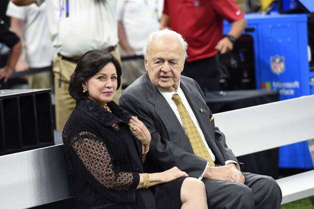 New Orleans Saints owner Tom Benson sits on the sideline with his wife Gayle Benson before an NFL football game against the New England Patriots in New Orleans, Sunday, Sept. 17, 2017. (AP Photo/Bill Feig)