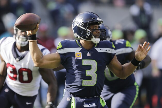 Seattle Seahawks quarterback Russell Wilson passes against the Houston Texans in the first half of an NFL football game, Sunday, Oct. 29, 2017, in Seattle. (AP Photo/Stephen Brashear)