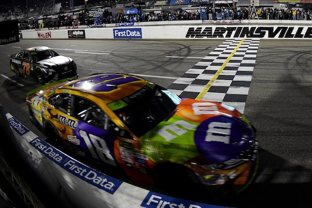 MARTINSVILLE, VA - OCTOBER 29:  Kyle Busch, driver of the #18 M&M's Halloween Toyota, takes the checkered flag to win the Monster Energy NASCAR Cup Series First Data 500 at Martinsville Speedway on October 29, 2017 in Martinsville, Virginia.  (Photo by Stacy Revere/Getty Images)