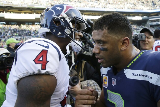 Houston Texans quarterback Deshaun Watson (4) shakes hands with Seattle Seahawks quarterback Russell Wilson, right, after an NFL football game, Sunday, Oct. 29, 2017, in Seattle. The Seahawks won 41-38. (AP Photo/Stephen Brashear)