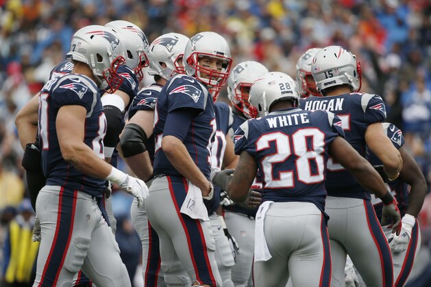 New England Patriots quarterback Tom Brady, center, joins his team in the huddle during the first half of an NFL football game against the Los Angeles Chargers, Sunday, Oct. 29, 2017, in Foxborough, Mass. (AP Photo/Michael Dwyer)