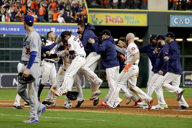 The Houston Astros celebrates after Alex Bregman game winning single during Game 5 of baseball's World Series against the Los Angeles Dodgers Monday, Oct. 30, 2017, in Houston. Astros won 13-12. (AP Photo/Matt Slocum)
