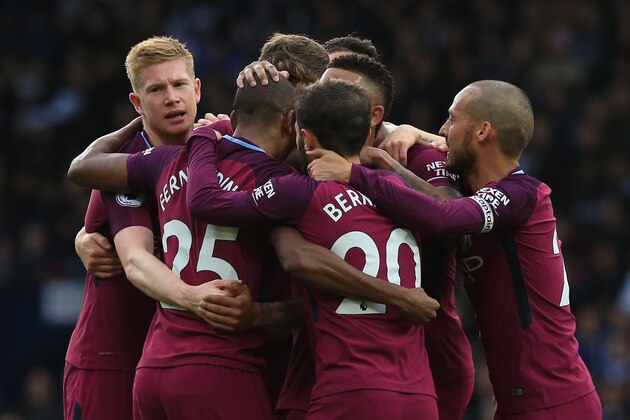 Manchester City's Brazilian midfielder Fernandinho (C) celebrates with teammates, scoring the team's second goal during the English Premier League football match between West Bromwich Albion and Manchester City at The Hawthorns stadium in West Bromwich, central England, on October 28, 2017.
 / AFP PHOTO / Lindsey PARNABY / RESTRICTED TO EDITORIAL USE. No use with unauthorized audio, video, data, fixture lists, club/league logos or 'live' services. Online in-match use limited to 75 images, no video emulation. No use in betting, games or single club/league/player publications.  /         (Photo credit should read LINDSEY PARNABY/AFP/Getty Images)