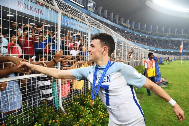 England's midfielder Phil Foden greets spectators after England's win over Spain in the final FIFA U-17 World Cup football match at the Vivekananda Yuba Bharati Krirangan stadium in Kolkata on October 28, 2017. / AFP PHOTO / Dibyangshu SARKAR        (Photo credit should read DIBYANGSHU SARKAR/AFP/Getty Images)