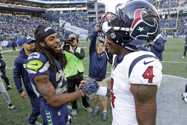 Seattle Seahawks' Richard Sherman, left, greets Houston Texans quarterback Deshaun Watson after an NFL football game, Sunday, Oct. 29, 2017, in Seattle. The Seahawks won 41-38. (AP Photo/Elaine Thompson)