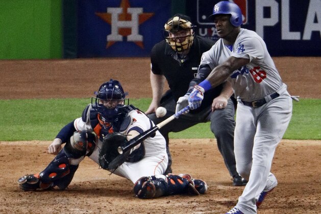 Los Angeles Dodgers' Yasiel Puig hits two-run home run against the Houston Astros during the ninth inning of Game 5 of baseball's World Series Sunday, Oct. 29, 2017, in Houston. (AP Photo/Charlie Riedel)