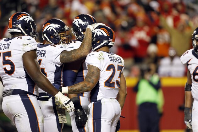 Denver Broncos wide receiver Cody Latimer (14) congratulates running back Devontae Booker (23) after he scored a touchdown during the second half of an NFL football game against the Kansas City Chiefs in Kansas City, Mo., Monday, Oct. 30, 2017. (AP Photo/Colin E. Braley)