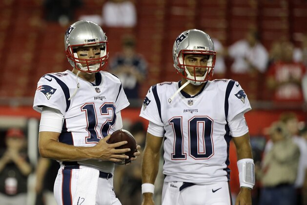 New England Patriots quarterback Tom Brady (12) and quarterback Jimmy Garoppolo (10) warm up before an NFL football game against the Tampa Bay Buccaneers, Thursday, Oct. 5, 2017, in Tampa, Fla. (AP Photo/John Raoux)