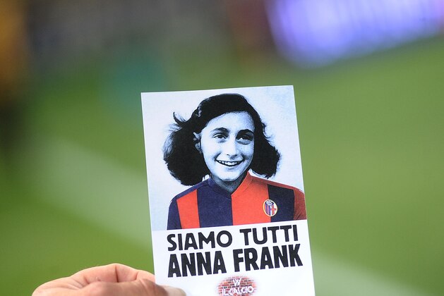 BOLOGNA, ITALY - OCTOBER 25:  A sticker with the image of Anna Frank wearing the jersey of Bologna FC that says 'We are all Anne Frank'  is given to all supporters at the gates of the stadio Renato Dall'ara prior the beginning of  the Serie A match between Bologna FC and SS Lazio at Stadio Renato Dall'Ara on October 25, 2017 in Bologna, Italy.  (Photo by Mario Carlini / Iguana Press/Getty Images)