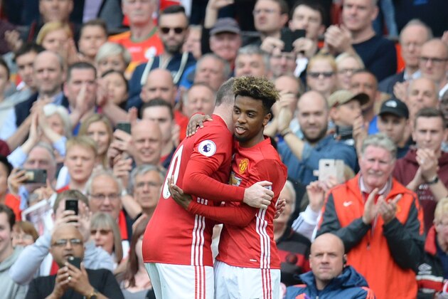 Manchester United's English striker Wayne Rooney (L) is substituted for Manchester United's English midfielder Angel Gomes (R) during the English Premier League football match between Manchester United and Cyrstal Palace at Old Trafford in Manchester, north west England, on May 21, 2017. / AFP PHOTO / Oli SCARFF / RESTRICTED TO EDITORIAL USE. No use with unauthorized audio, video, data, fixture lists, club/league logos or 'live' services. Online in-match use limited to 75 images, no video emulation. No use in betting, games or single club/league/player publications.  /         (Photo credit should read OLI SCARFF/AFP/Getty Images)