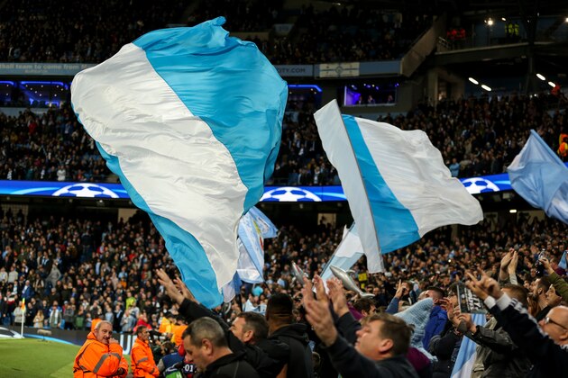 MANCHESTER, ENGLAND - OCTOBER 17: Fans of Manchester City wave flags during the UEFA Champions League group F match between Manchester City and SSC Napoli at Etihad Stadium on October 17, 2017 in Manchester, United Kingdom. (Photo by Robbie Jay Barratt - AMA/Getty Images)