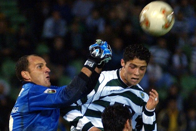 Gil Vicente's goalie Paulo Jorge, left, clears the ball before Sporting's Cesar Ronaldo, right, during their Portuguese Super League match Saturday, Nov. 2 2002, in Lisbon, Portugal.  (AP Photo/Armando Franca)
