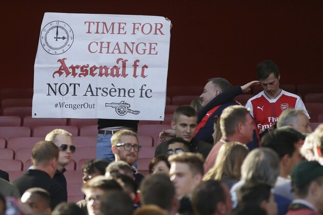 An Arsenal fan holds up a protest banner after the English Premier League soccer match between Arsenal and Everton at The Emirates stadium in London, Sunday May 21, 2017. (AP Photo/Tim Ireland)