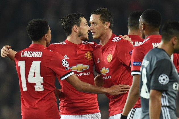Manchester United's Serbian midfielder Nemanja Matic (C) celebrates his part in the opening goal with teammates during the UEFA Champions League Group A football match between Manchester United and Benfica at Old Trafford in Manchester, north west England on October 31, 2017. / AFP PHOTO / Oli SCARFF        (Photo credit should read OLI SCARFF/AFP/Getty Images)