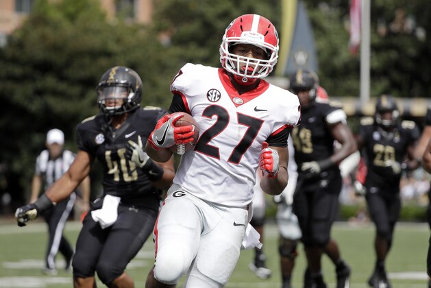 Georgia running back Nick Chubb (27) scores a touchdown against Vanderbilt on a 14-yard run in the first half of an NCAA college football game Saturday, Oct. 7, 2017, in Nashville, Tenn. (AP Photo/Mark Humphrey)