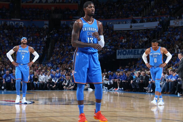 OKLAHOMA CITY, OK- OCTOBER 19:  Paul George #13 shoots a foul shot while Carmelo Anthony #7 and Russell Westbrook #0 of the Oklahoma City Thunder look during the game against the New York Knicks on October 19, 2017 at Chesapeake Energy Arena in Oklahoma City, Oklahoma. NOTE TO USER: User expressly acknowledges and agrees that, by downloading and or using this photograph, User is consenting to the terms and conditions of the Getty Images License Agreement. Mandatory Copyright Notice: Copyright 2017 NBAE (Photo by Layne Murdoch Sr./NBAE via Getty Images)