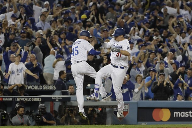 Los Angeles Dodgers' Joc Pederson celebrates his home run with third base coach Chris Woodward during the seventh inning of Game 6 of baseball's World Series against the Houston Astros Tuesday, Oct. 31, 2017, in Los Angeles. (AP Photo/David J. Phillip)