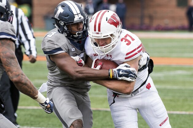 Illinois linebacker Del'Shawn Phillips (3) tries to tackle Wisconsin running back Garrett Groshek (37) during the fourth quarter of an NCAA college football game, Saturday, Oct. 28, 2017, at Memorial Stadium in Champaign, Ill. Wisconsin defeated Illinois 24-10. (AP Photo/Bradley Leeb)