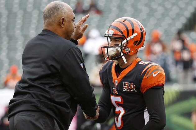 Cincinnati Bengals quarterback AJ McCarron (5) and head coach Marvin Lewis, left, meet on the field during practice before an NFL football game against the Indianapolis Colts, Sunday, Oct. 29, 2017, in Cincinnati. (AP Photo/Frank Victores)