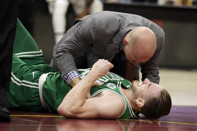 Boston Celtics' Gordon Hayward grimaces in pain in the first half of an NBA basketball game against the Cleveland Cavaliers, Tuesday, Oct. 17, 2017, in Cleveland. Just five minutes into his Boston career, new Celtics star forward Gordon Hayward gruesomely broke his left ankle, an injury that may end his season. (AP Photo/Tony Dejak)