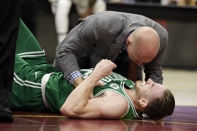 Boston Celtics' Gordon Hayward grimaces in pain in the first half of an NBA basketball game against the Cleveland Cavaliers, Tuesday, Oct. 17, 2017, in Cleveland. Just five minutes into his Boston career, new Celtics star forward Gordon Hayward gruesomely broke his left ankle, an injury that may end his season. (AP Photo/Tony Dejak)