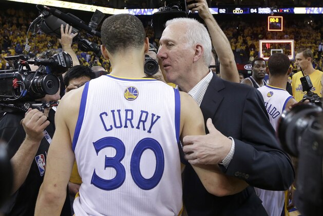 San Antonio Spurs head coach Gregg Popovich, right, talks with Golden State Warriors shooting guard Stephen Curry (30) after Game 6 of a Western Conference semifinal NBA basketball playoff series in Oakland, Calif., Thursday, May 16, 2013. San Antonio won 94-82. (AP Photo/Jeff Chiu)