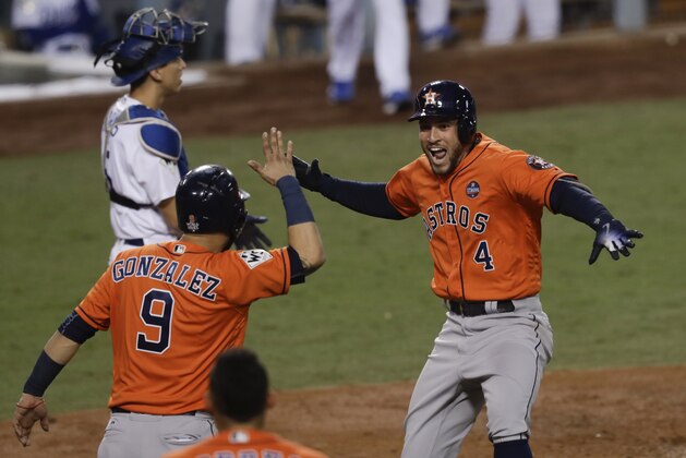 Houston Astros' George Springer (4) celebrates after his two-run home run against the Los Angeles Dodgers during the second inning of Game 7 of baseball's World Series Wednesday, Nov. 1, 2017, in Los Angeles. (AP Photo/Alex Gallardo)