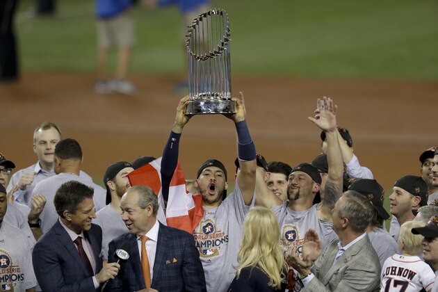 The Houston Astros' Carlos Correa celebrates with the trophy after their win against the Los Angeles Dodgers in Game 7 of baseball's World Series Wednesday, Nov. 1, 2017, in Los Angeles. The Astros won 5-1 to win the series 4-3. (AP Photo/Alex Gallardo)