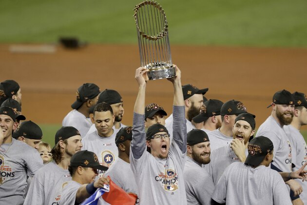 The Houston Astros celebrate with the trophy after their win against the Los Angeles Dodgers in Game 7 of baseball's World Series Wednesday, Nov. 1, 2017, in Los Angeles. The Astros won 5-1 to win the series 4-3. (AP Photo/Alex Gallardo)