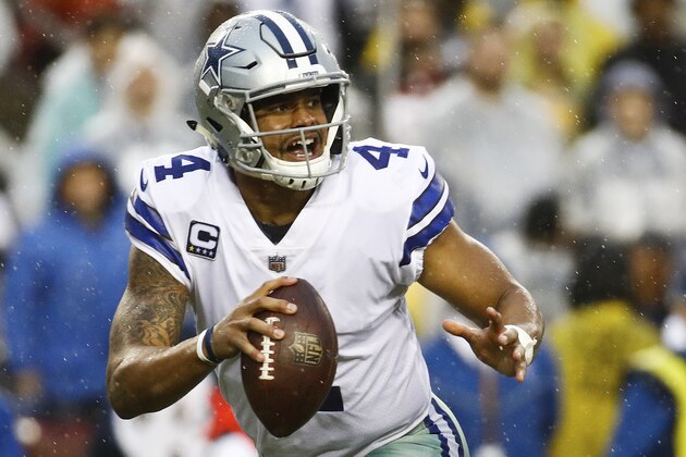 Dallas Cowboys quarterback Dak Prescott (4) scrambles with the ball during the first half of an NFL football game against the Washington Redskins in Landover, Md., Sunday, Oct. 29, 2017. (AP Photo/Patrick Semansky)