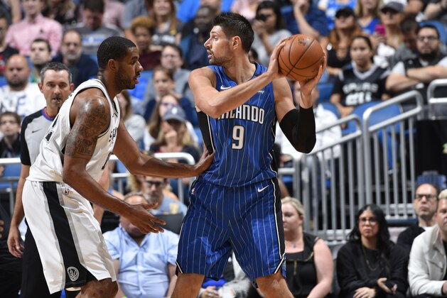 ORLANDO, FL - OCTOBER 27:  Nikola Vucevic #9 of the Orlando Magic handles the ball against the San Antonio Spurs on October 27, 2017 at Amway Center in Orlando, Florida. NOTE TO USER: User expressly acknowledges and agrees that, by downloading and or using this photograph, User is consenting to the terms and conditions of the Getty Images License Agreement. Mandatory Copyright Notice: Copyright 2017 NBAE (Photo by Fernando Medina/NBAE via Getty Images)