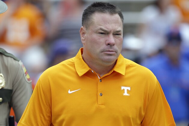 Tennessee head coach Butch Jones takes the field before the first half of an NCAA college football game against Florida, Saturday, Sept. 16, 2017, in Gainesville, Fla. (AP Photo/John Raoux)