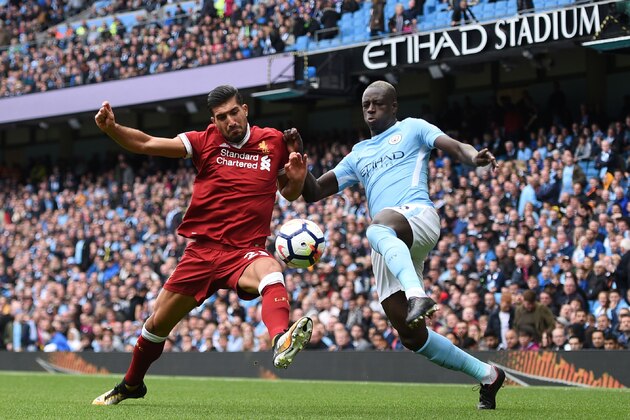 Liverpool's German midfielder Emre Can (L) vies with Manchester City's French defender Benjamin Mendy during the English Premier League football match between Manchester City and Liverpool at the Etihad Stadium in Manchester, north west England, on September 9, 2017. / AFP PHOTO / Oli SCARFF / RESTRICTED TO EDITORIAL USE. No use with unauthorized audio, video, data, fixture lists, club/league logos or 'live' services. Online in-match use limited to 75 images, no video emulation. No use in betting, games or single club/league/player publications.  /         (Photo credit should read OLI SCARFF/AFP/Getty Images)