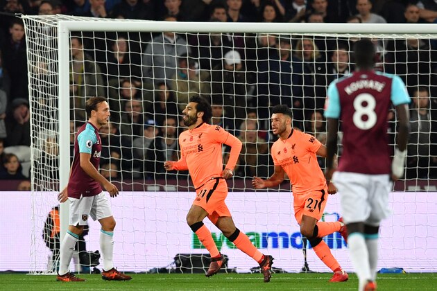 Liverpool's Egyptian midfielder Mohamed Salah (C) celebrates after scoring during the English Premier League football match between West Ham United and Liverpool at The London Stadium, in east London on November 4, 2017. / AFP PHOTO / Ben STANSALL / RESTRICTED TO EDITORIAL USE. No use with unauthorized audio, video, data, fixture lists, club/league logos or 'live' services. Online in-match use limited to 75 images, no video emulation. No use in betting, games or single club/league/player publications.  /         (Photo credit should read BEN STANSALL/AFP/Getty Images)