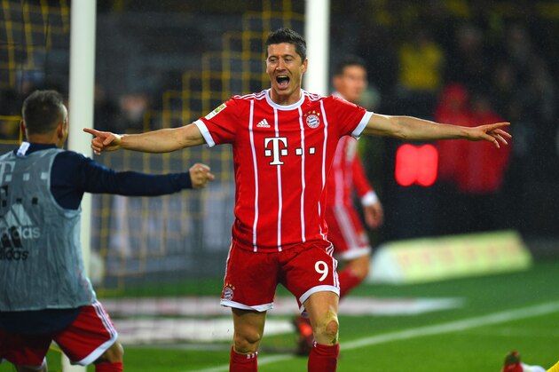 Bayern Munich´s Polish striker Robert Lewandowski celebrates during the German First division Bundesliga football match Borussia Dortmund vs Bayern Munich in Dortmund, western Germany, on November 4, 2017. / AFP PHOTO / PATRIK STOLLARZ / RESTRICTIONS: DURING MATCH TIME: DFL RULES TO LIMIT THE ONLINE USAGE TO 15 PICTURES PER MATCH AND FORBID IMAGE SEQUENCES TO SIMULATE VIDEO. == RESTRICTED TO EDITORIAL USE == FOR FURTHER QUERIES PLEASE CONTACT DFL DIRECTLY AT + 49 69 650050
        (Photo credit should read PATRIK STOLLARZ/AFP/Getty Images)