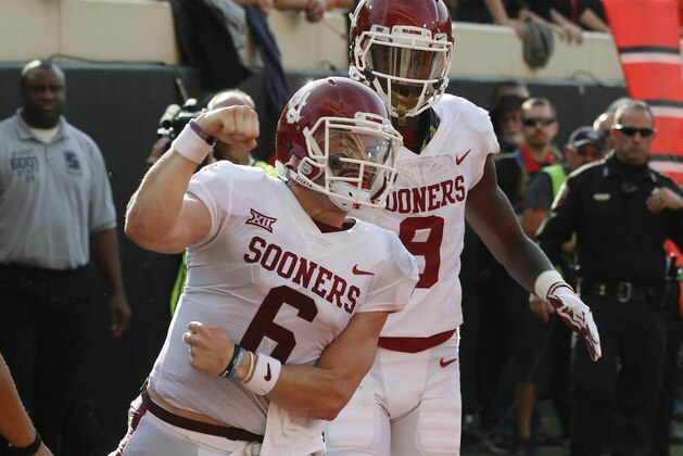 Oklahoma quarterback Baker Mayfield (6) celebrates a touchdown against Oklahoma State in the first half of an NCAA college football game in Stillwater, Okla., Saturday, Nov. 4, 2017. Oklahoma wide receiver CeeDee Lamb is at right. (AP Photo/Sue Ogrocki)