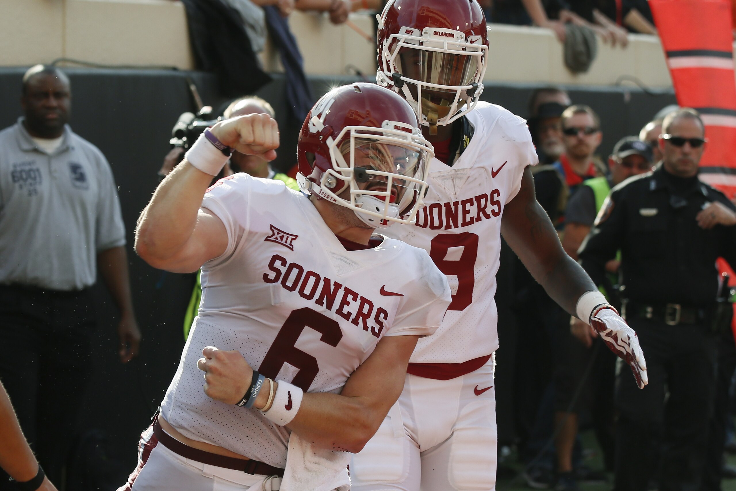 Oklahoma quarterback Baker Mayfield (6) celebrates a touchdown against Oklahoma State in the first half of an NCAA college football game in Stillwater, Okla., Saturday, Nov. 4, 2017. Oklahoma wide receiver CeeDee Lamb is at right. (AP Photo/Sue Ogrocki)