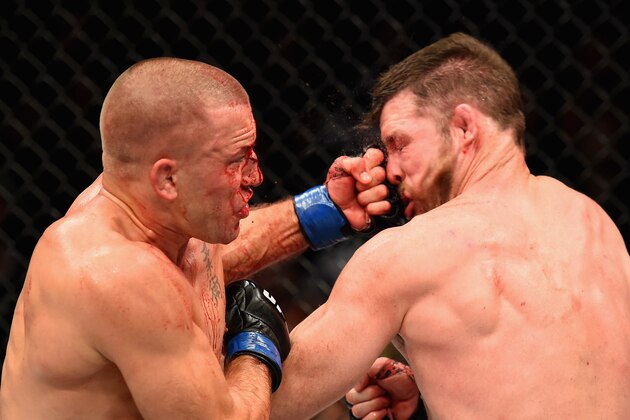NEW YORK, NY - NOVEMBER 04:  Georges St-Pierre of Canada lands a punch to take down Michael Bisping of England in their UFC middleweight championship bout during the UFC 217 event at Madison Square Garden on November 4, 2017 in New York City.  (Photo by Josh Hedges/Zuffa LLC/Zuffa LLC via Getty Images)