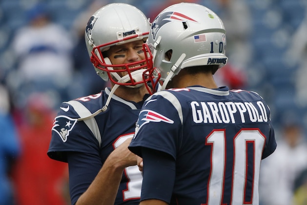 New England Patriots quarterbacks Tom Brady, left, and Jimmy Garoppolo warm up before an NFL football game against the Los Angeles Chargers, Sunday, Oct. 29, 2017, in Foxborough, Mass. (AP Photo/Michael Dwyer)
