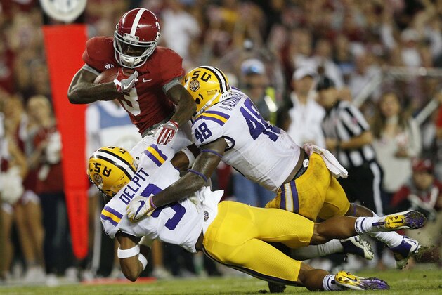 Alabama wide receiver Calvin Ridley is tackled by LSU linebacker Donnie Alexander, and safety Grant Delpit, left, during the second half of an NCAA college football game, Saturday, Nov. 4, 2017, in Tuscaloosa, Ala. (AP Photo/Brynn Anderson)