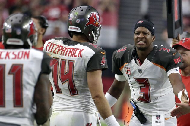 FILE - In this Oct. 15, 2017, file photo, Tampa Bay Buccaneers quarterback Jameis Winston (3) congratulates backup quarterback Ryan Fitzpatrick during an NFL football game against the Arizona Cardinals, Sunday, in Glendale, Ariz. With Winston's status uncertain because of an injured throwing shoulder, the Buccaneers begin preparation for the Buffalo Bills with Fitzpatrick at quarterback. (AP Photo/Rick Scuteri, File)