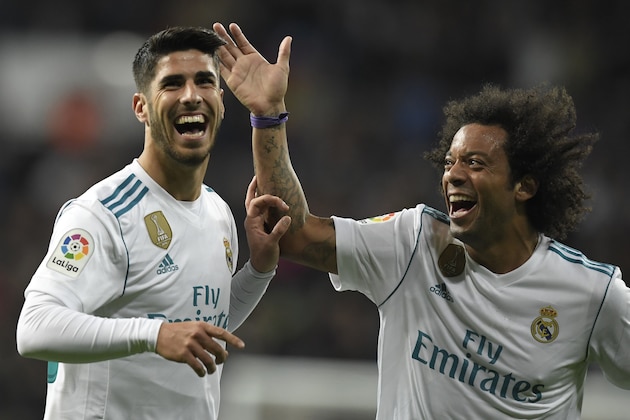 Real Madrid's Spanish midfielder Marco Asensio celebrates with Real Madrid's Brazilian defender Marcelo (R) after scoring a goal during the Spanish league football match Real Madrid CF vs UD Las Palmas at the Santiago Bernabeu stadium in Madrid on November 5, 2017. / AFP PHOTO / GABRIEL BOUYS        (Photo credit should read GABRIEL BOUYS/AFP/Getty Images)