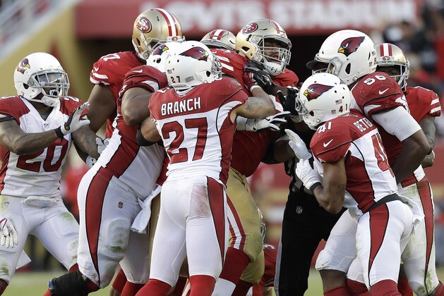 San Francisco 49ers offensive guard Laken Tomlinson, center, shoves Arizona Cardinals players during the second half of an NFL football game in Santa Clara, Calif., Sunday, Nov. 5, 2017. (AP Photo/Marcio Jose Sanchez)