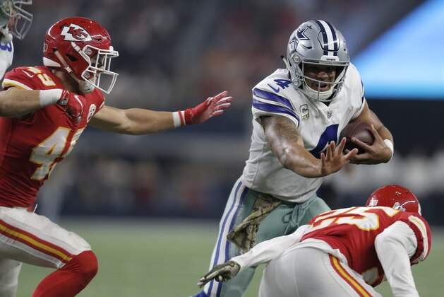 Kansas City Chiefs' Daniel Sorensen (49) and Kenneth Acker (25) attempt to stop Dallas Cowboys' Dak Prescott (4) as he runs the ball in the second half of an NFL football game, Sunday, Nov. 5, 2017, in Arlington, Texas. (AP Photo/Brandon Wade)